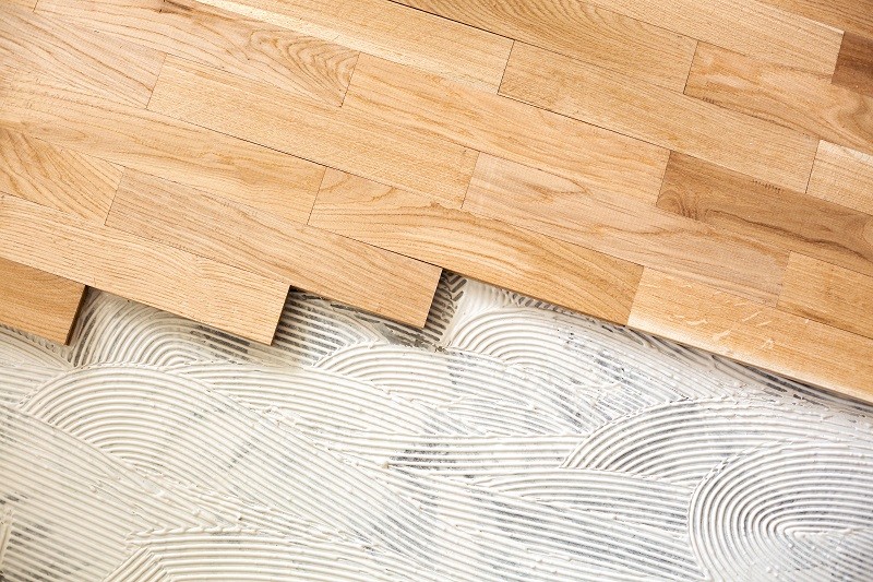 closeup of subfloor mixture and assembled parquet plates in the working environment | Tish flooring